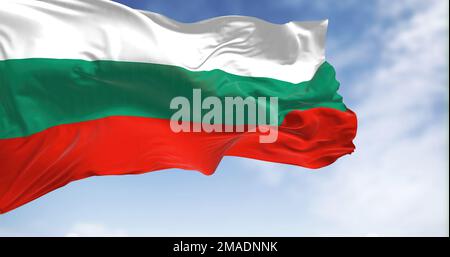 Close-up view of the Bulgaria national flag waving in the wind. Bulgaria flag is white-green-red horizontal stripes. Rippled fabric. Textured backgrou Stock Photo