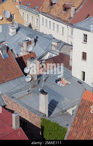 Estonia, Tallinn, sun bathers on hot tin roof Stock Photo - Alamy