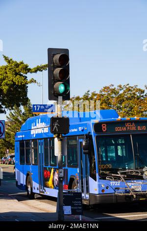 Big Blue Bus at green traffic light signal on Ocean Park Boulevard and 17th Street. Santa Monica, California, USA Stock Photo