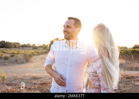 Happy couple in a mediterranean location at sunset Stock Photo