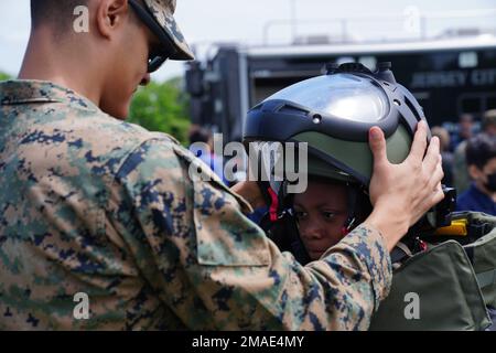 A student from Philip G. Vroom Community School tries on an EOD Advanced Bomb Suit during Fleet Week New York 2022 at Lincoln Park, New Jersey, May 26th, 2022. Fleet Week New York has been held nearly every year since 1984 to celebrate the nation’s maritime services and highlight their innovative capabilities, while providing an opportunity for the citizens of New York City and the surrounding tristate area to meet Sailors, Marines and Coast Guardsmen. Stock Photo