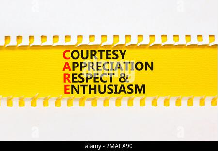 CARE symbol. Concept words CARE courtesy appreciation respect and enthusiasm on yellow paper on beautiful white background. Business CARE courtesy app Stock Photo