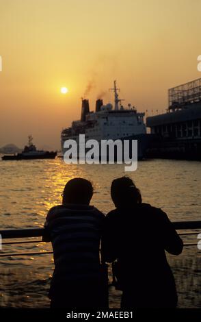 Hong Kong, Kowloon, cruise ship docking at sunset. Stock Photo