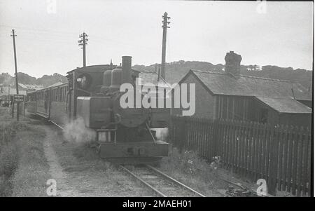 Welsh Highland Railway Baldwin 4-6-0T locomotive No. 590  is alongside Gelerts Farm. Stock Photo