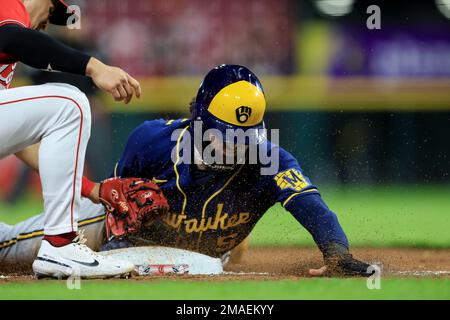 Milwaukee Brewers center fielder Garrett Mitchell leaves the game with a  shoulder injury, accompanied by head athletic trainer Scott Barringer,  center, and manager Craig Counsell, right, during a baseball game against  the