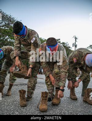 Blindfolded competitors, including U.S. Army Staff Sgt. Jackson Fagan with the Utah Army National Guard Recruiting and Retention Battalion, prepare for the mystery event blindfolded during the Region VII Best Warrior Competition on the island of Guam, May 26, 2022. This annual competition featured the best noncommissioned officer and Soldier from eight different states and territories including Arizona, California, Colorado, Guam, Hawaii, Nevada, New Mexico, and Utah. Testing competitors’ skills and knowledge and pushing them to their limits, the competition graded each participant in key area Stock Photo