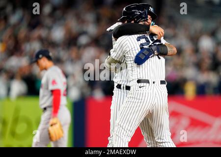 New York Yankees' Gleyber Torres (25) is congratulated by Josh Donaldson  after hitting a home run against the Boston Red Sox during the fourth  inning of a baseball game Saturday, June 10