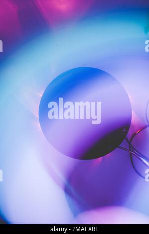 black frying pan in the dark on a white background with blurred lights in a long exposure Stock Photo
