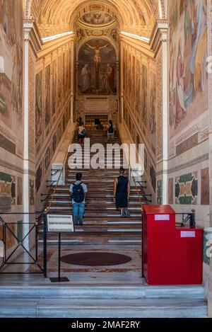 Pilgrims Climbing The Holy Stairs of Sancta Scala on their knees in Rome, Italy Stock Photo