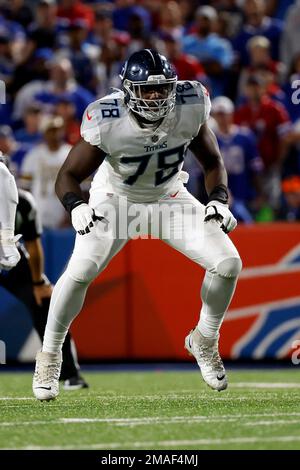 Tennessee Titans offensive lineman Nicholas Petit-Frere (78) runs onto the  field with a member of the military during a Salute to Service pregame  ceremony before an NFL football game between the Denver