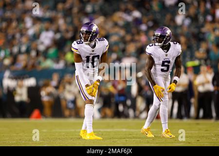 Minnesota Vikings wide receivers Justin Jefferson (18) and Adam Thielen (19)  celebrate after Jefferson scored a touchdown against the New York Jets,  during the second half of an NFL football game Sunday