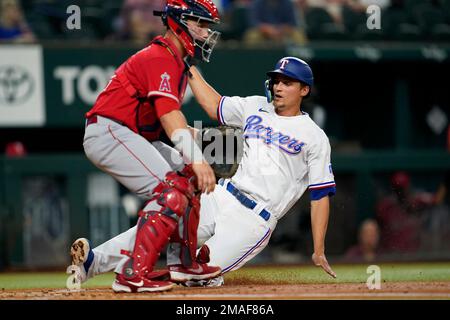 Texas Rangers' Corey Seager, Adolis Garcia and Marcus Semien, from left,  celebrate the team's 5-0 win over the Los Angeles Angels in a baseball game  Wednesday, Sept. 27, 2023, in Anaheim, Calif. (