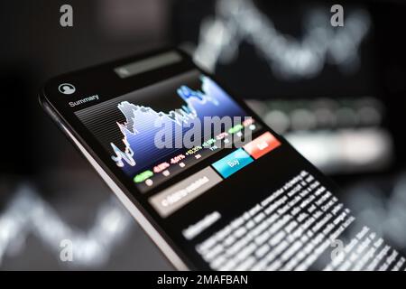 Stock market trade app in mobile phone. Crypto currency or forex concept. Chart and graph analysis data in smartphone.  Future prediction index. Stock Photo