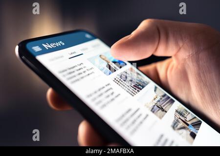 News feed in phone. Watching and reading latest online articles and headlines from smartphone newspaper mobile app. Daily digital information portal. Stock Photo