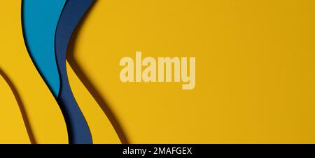 Abstract colored paper texture background. Minimal paper cut composition with layers of geometric shapes and lines in light blue, navy blue, yellow Stock Photo