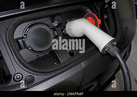 White charging cable plugged into Type 2 charging socket on 59kW Nissan Leaf e+ Stock Photo