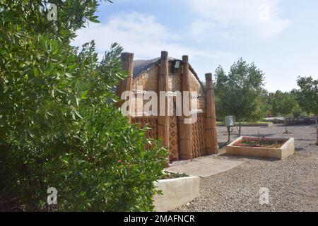 A traditional Iraqi reed house with trees used for guests and ceremonies Stock Photo