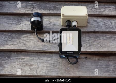 10W LED energy efficient outside automaticfloodlight controlled by adjacent sensor unit. Stock Photo