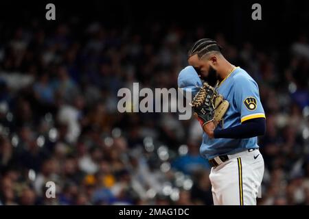 Milwaukee Brewers' Devin Williams pauses before pitching during