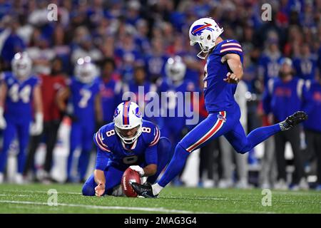 Buffalo Bills kicker Tyler Bass, right, kicks a field goal from the hold of  punter Sam Martin during the first half an NFL preseason football game  against the Indianapolis Colts in Orchard