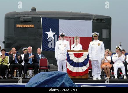 060909-N-0653J-005. [Complete] Scene Caption: The First Lady, Mrs. Laura Bush, delivers her remarks during the commissioning ceremony of the Virginia Class New Attack Submarine USS TEXAS (775) at Galveston, Texas, on Sept. 9, 2006. The second boat in her class, TEXAS is able to attack targets ashore with highly accurate cruise missiles and conduct covert long-term surveillance of land areas, littoral waters or other naval forces. Other missions include anti-submarine and anti-ship warfare, special forces delivery and support, mine delivery and minefield mapping. Also in the photo beside the Fi Stock Photo