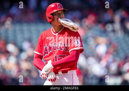 Los Angeles Angels designated hitter Shohei Ohtani changes out his hitting  gloves for base-running gloves while on first base during the third inning  of a baseball game against the Seattle Mariners in