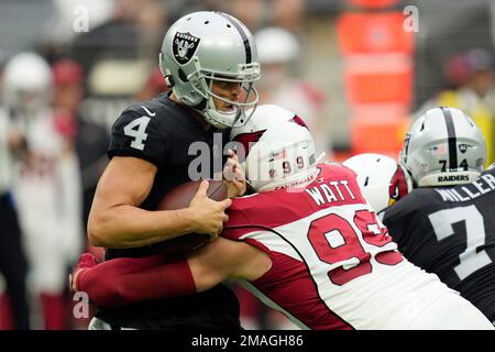 Las Vegas Raiders quarterback Derek Carr (4) is sacked by Arizona Cardinals  defensive end J.J. Watt (99) during the first half of an NFL football game  Sunday, Sept. 18, 2022, in Las