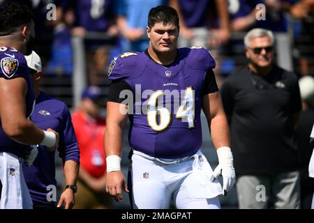 Baltimore Ravens center Tyler Linderbaum (64) signals during an