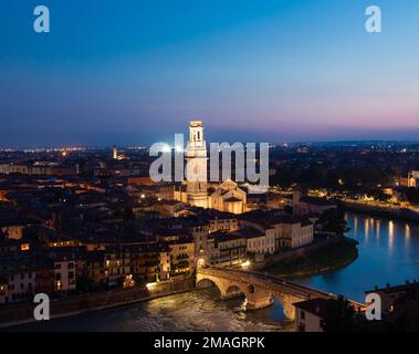 Verona, Italy - June 2022: panorama by night. Illuminated cityscape with scenic bridge Stock Photo