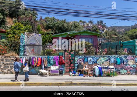 Valparaiso, Chile - Dec 5, 2022: Women selling clothes in the middle of the street in a poor neighborhood od Valparaiso Stock Photo