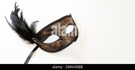Carnival mask brown color with black feather decoration isolated on white background Stock Photo