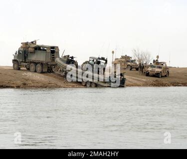 070315-M-6500K-015. [Complete] Scene Caption: March 5, 2007, Riverine Squadron (RIVRON-), Detachment 3, st Brigade, 3rd Infantry Division, II Marine Expeditionary Force prepare to launch a Small Unit Reconassance Craft (SURC) for Operation Gibraltar. The operation consisted of inserting at Riverine Launch Site 4 in Ramadi and extracting at the Al Taqaddum Riverine Launch Site. The operation is to familiarize the arriving RIVRON- with the area that Dam Security Unit 3 (DSU-3), st Brigade, 3rd Infantry Division, II Marine Expeditionary Force has been covering for the past six months. RIVRON- and Stock Photo