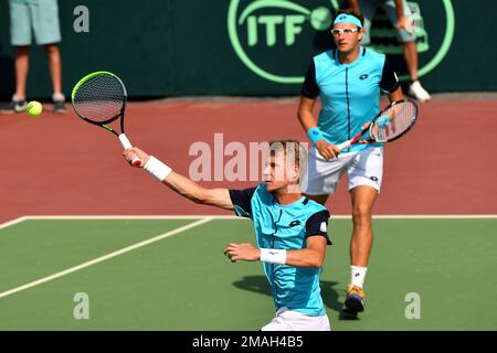 Uzbekistan's Sanjar Fayziev, foreground and Denis Istomin return a