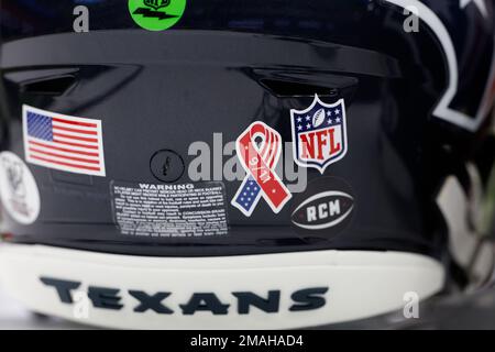 Houston Texans player seen from the back with the American flag, 9-11 and NFL  shield decals on his helmet during pregame warmups before an NFL football  game against the Indianapolis Colts on