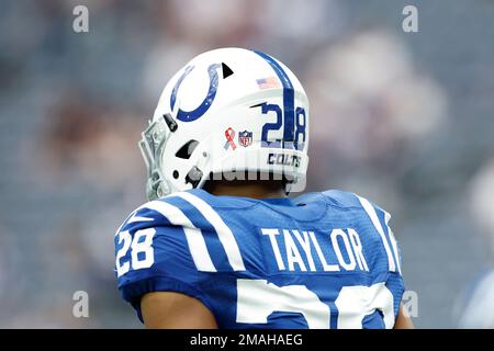 Houston Texans player seen from the back with the American flag, 9-11 and NFL  shield decals on his helmet during pregame warmups before an NFL football  game against the Indianapolis Colts on