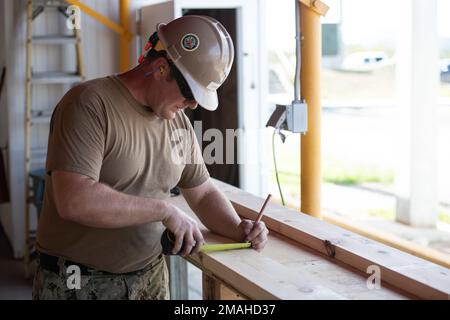 (220526-N-OI810-0754) KEY WEST, Florida (May 26, 2022) Builder 1st Class Steven Arkin, from Long Beach, Mississippi, assigned to Naval Mobile Construction Battalion (NMCB) 14, rebuilds a table at Boca Chica Air Field small arms range, Naval Air Station Key West (NASKW), May 26, 2016. Seabees assigned to NMCB-14 travelled to NASKW to perform on-site training and assist with facility and compound maintenance. NMCB-14 provides advance base construction, battle damage repair, contingency engineering, humanitarian assistance and disaster recovery support to our fleet and unified commanders. Stock Photo