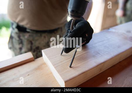 (220526-N-OI810-0812) KEY WEST, Florida (May 26, 2022) Builder 1st Class Steven Arkin, from Long Beach, Mississippi, assigned to Naval Mobile Construction Battalion (NMCB) 14, rebuilds a table at Boca Chica Air Field small arms range, Naval Air Station Key West (NASKW), May 26, 2016. Seabees assigned to NMCB-14 travelled to NASKW to perform on-site training and assist with facility and compound maintenance. NMCB-14 provides advance base construction, battle damage repair, contingency engineering, humanitarian assistance and disaster recovery support to our fleet and unified commanders. Stock Photo