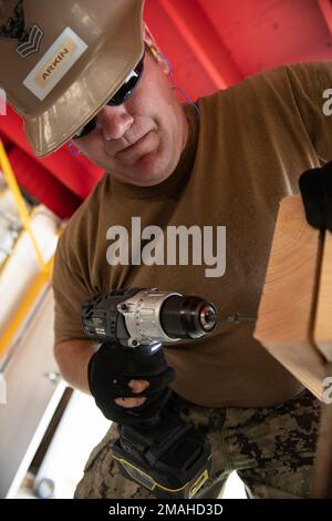 (220526-N-OI810-0869) KEY WEST, Florida (May 26, 2022) Builder 1st Class Steven Arkin, from Long Beach, Mississippi, assigned to Naval Mobile Construction Battalion (NMCB) 14, rebuilds a table at Boca Chica Air Field small arms range, Naval Air Station Key West (NASKW), May 26, 2016. Seabees assigned to NMCB-14 travelled to NASKW to perform on-site training and assist with facility and compound maintenance. NMCB-14 provides advance base construction, battle damage repair, contingency engineering, humanitarian assistance and disaster recovery support to our fleet and unified commanders. Stock Photo