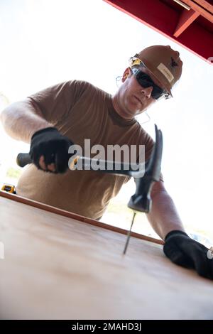 (220526-N-OI810-0881) KEY WEST, Florida (May 26, 2022) Builder 1st Class Steven Arkin, from Long Beach, Mississippi, assigned to Naval Mobile Construction Battalion (NMCB) 14, rebuilds a table at Boca Chica Air Field small arms range, Naval Air Station Key West (NASKW), May 26, 2016. Seabees assigned to NMCB-14 travelled to NASKW to perform on-site training and assist with facility and compound maintenance. NMCB-14 provides advance base construction, battle damage repair, contingency engineering, humanitarian assistance and disaster recovery support to our fleet and unified commanders. Stock Photo