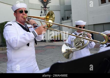 Hollywood, Calif. (May 27, 2022) – U.S. Navy Musician 2nd Class Ryan Miller, from Port Huron, Mich., assigned to Navy Band Southwest’s Brass Quintet, plays the trombone at the TCL Chinese Theatre during the premiere of Top Gun: Maverick as part of Los Angeles Fleet Week (LAFW) May 27, 2022. LAFW is an opportunity for the American public to meet their Navy, Marine Corps and Coast Guard teams and experience America's sea services. During fleet week, service members participate in various community service events, showcase capabilities and equipment to the community, and enjoy the hospitality of Stock Photo