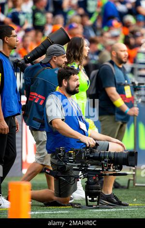 An NFL Films camera operator works during the first half of a