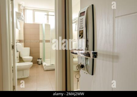 Close up on the opened door with modern key lock of hotel motel room Stock Photo