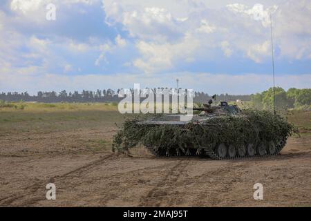 A Polish army BMP-1 infantry fighting vehicle advances onto the field at the start of a training exercise as part of Defender Europe at Mielno Range, Poland, May 27, 2022. Defender Europe 22 is a series of U.S. Army Europe and Africa multinational training exercises in Eastern Europe. The exercise demonstrates U.S. Army Europe and Africa’s ability to conduct large-scale ground combat operations across multiple theaters supporting NATO. Stock Photo