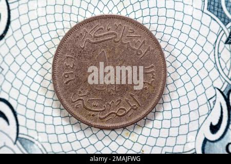 round metal ten Egyptian milliemes series 1941 AD 1360 AH features bust of King Farouk I of Egypt on obverse side and value and date on reverse side, Stock Photo