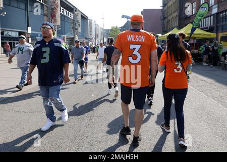 A Seattle Seahawks fan wearing a Russell Wilson jersey waves a