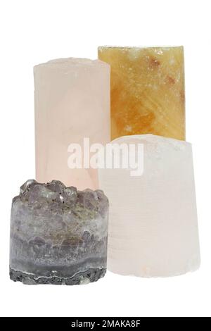 group of different drill cores isolated on white background (amethyst, rock crystal, orange calcite and rose quartz) Stock Photo