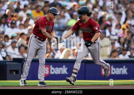 Arizona Diamondbacks' Buddy Kennedy, right, is congratulated by third base  coach Tony Perezchica after hitting an RBI triple against the San Diego  Padres in the fourth inning of a baseball game, Saturday