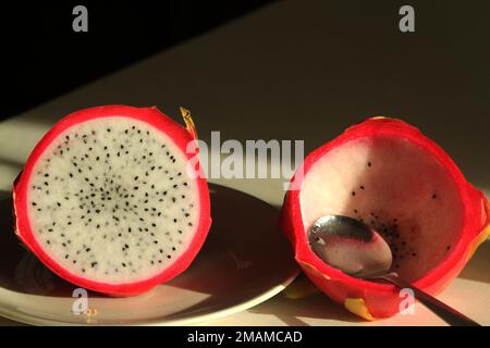 Dragon fruit on a plate, half eaten Stock Photo