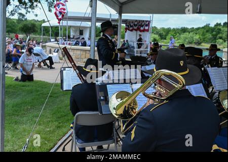 The U.S. Army 1st Cavalry Division Band from Fort Hood, Texas, performs for hundreds of visitors at the Dallas-Fort Worth National Cemetery’s wreath-laying ceremony May 30, 2022. Stock Photo