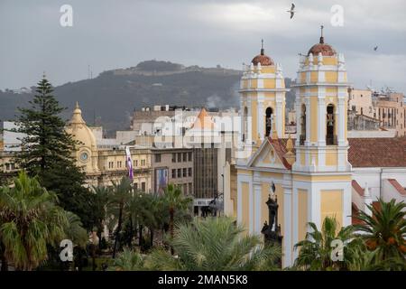 Ceuta, Spain - December 04, 2022: The bell towers of the Cathedral of Ceuta, with Mount Hacho in the background Stock Photo